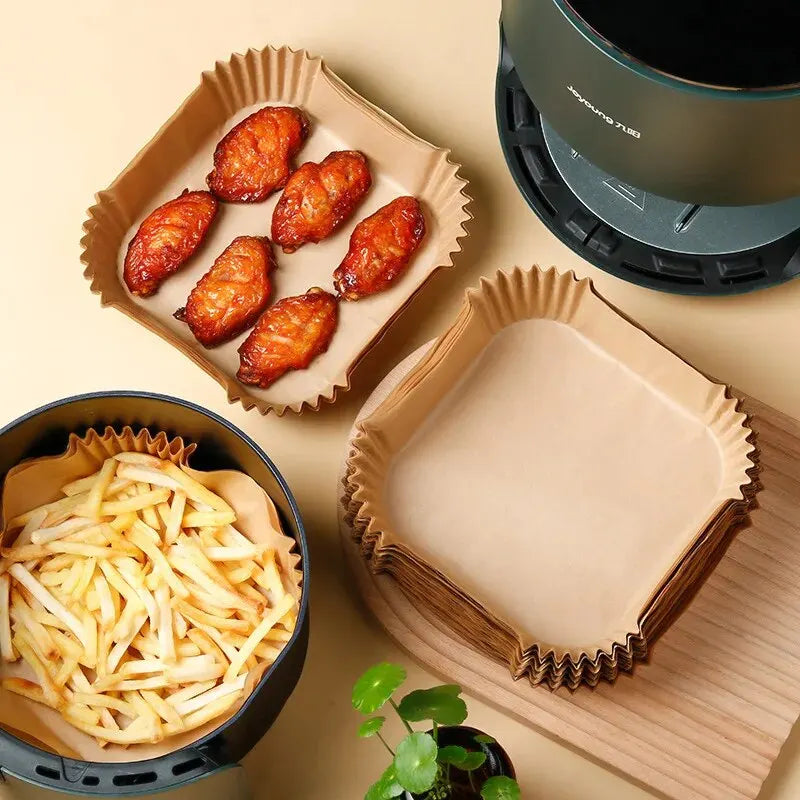 Air fryer disposable paper liners holding chicken wings and fries, perfect for cooking in an air fryer.